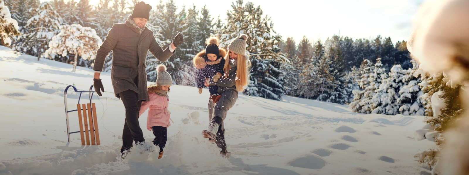 A family playing in the winter snow. 